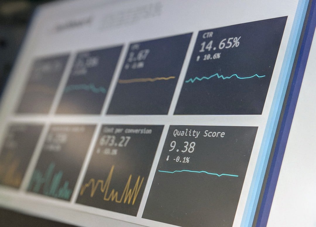 Data reporting dashboard displayed on a laptop screen in a dimly lit office