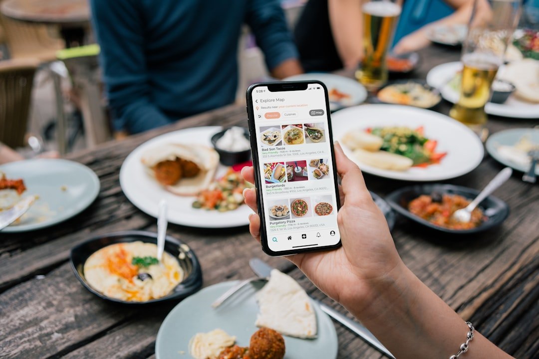 Person browsing a restaurant food app on a smartphone showing a Mediterranean dishes explore page