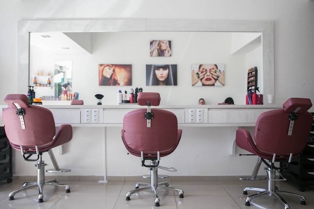 Bright hair salon interior with styling chairs, large mirrors, and pendant lighting