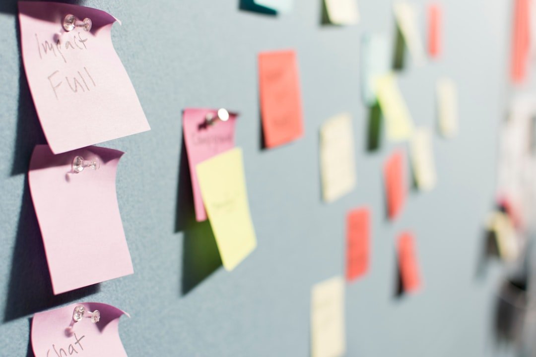 Colorful sticky notes arranged on a corkboard during a team brainstorming session